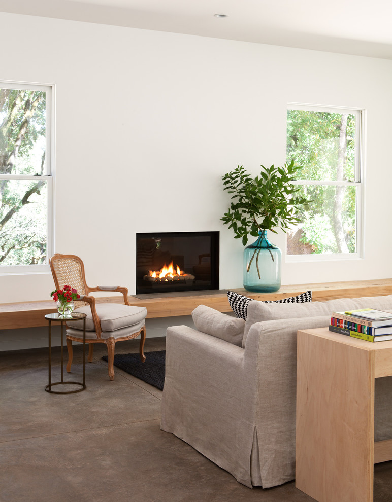 This is an example of a transitional living room in San Francisco with concrete floors.