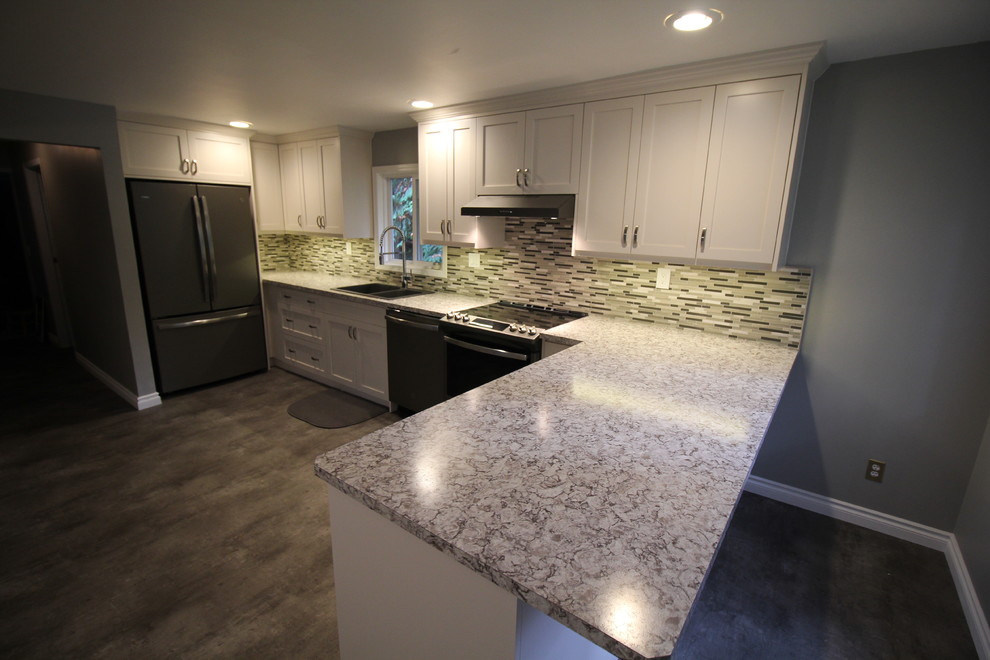 Eat-in kitchen - modern linoleum floor and gray floor eat-in kitchen idea with a drop-in sink, shaker cabinets, white cabinets, laminate countertops and glass tile backsplash