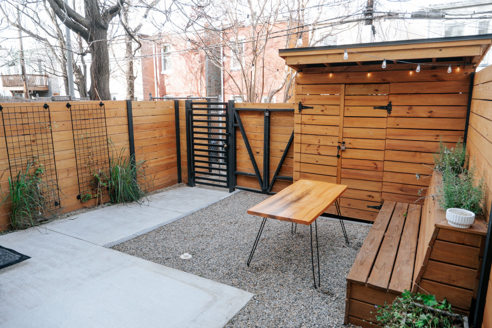 Design ideas for a small traditional back partial sun garden in DC Metro with decomposed granite and a wood fence.
