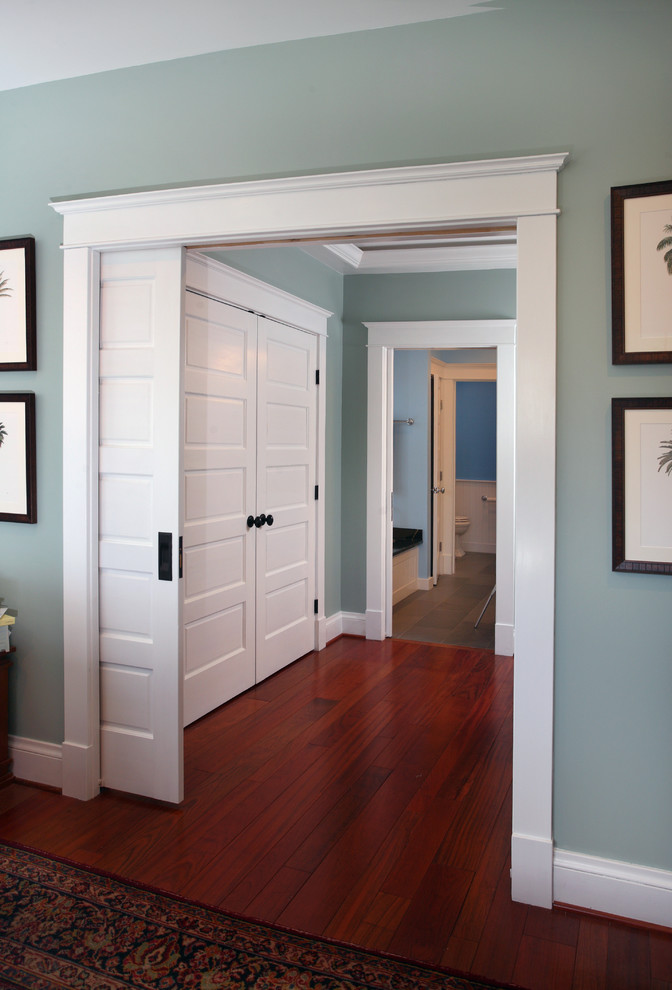 Photo of a mid-sized traditional master bedroom in DC Metro with blue walls, medium hardwood floors and no fireplace.
