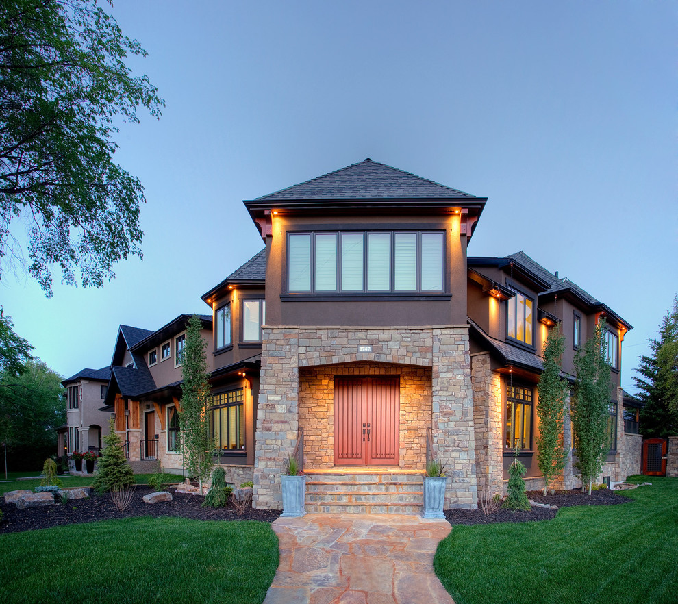 Inspiration for a traditional exterior in Calgary with stone veneer.