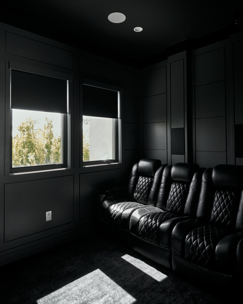 This is an example of a small contemporary enclosed home theatre in Los Angeles with grey walls, carpet, a projector screen and black floor.