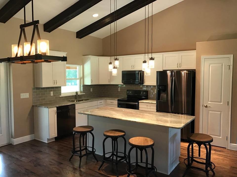 Mid-sized transitional l-shaped dark wood floor and brown floor open concept kitchen photo in Orlando with an undermount sink, recessed-panel cabinets, white cabinets, granite countertops, gray backsplash, subway tile backsplash, stainless steel appliances and an island