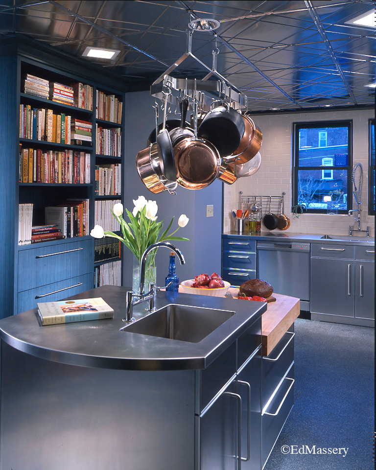 Inspiration for a modern kitchen remodel with an integrated sink, flat-panel cabinets, stainless steel cabinets, stainless steel countertops, ceramic backsplash, stainless steel appliances and an island