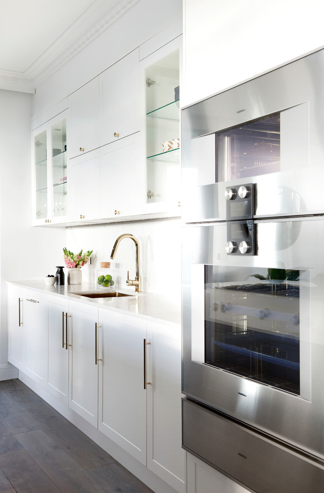 Design ideas for a large contemporary galley kitchen pantry in Melbourne with a single-bowl sink, shaker cabinets, yellow cabinets, quartz benchtops, yellow splashback, stone slab splashback, stainless steel appliances, medium hardwood floors and with island.