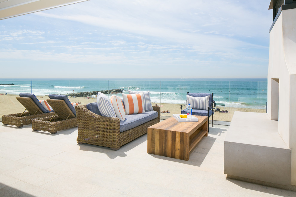 Photo of a beach style rooftop deck in Orange County with a fire feature and no cover.