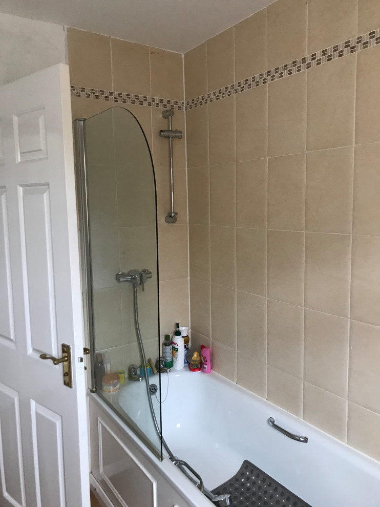 Tired old bathroom with shower over bath