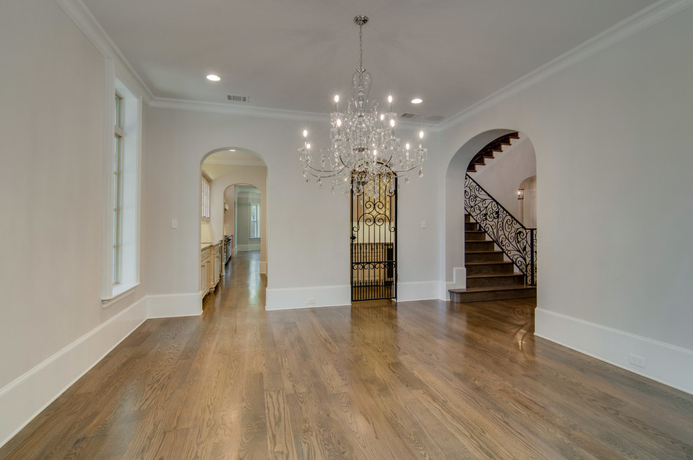 Design ideas for a large traditional separate dining room in Dallas with white walls and light hardwood floors.