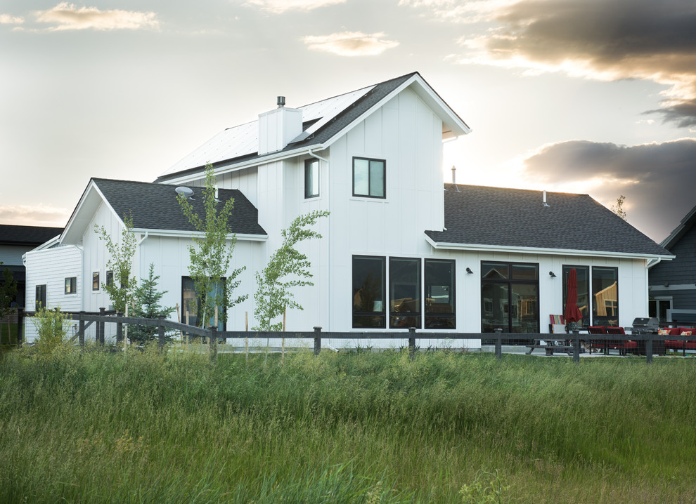 Mid-sized transitional white two-story concrete fiberboard exterior home photo with a shed roof