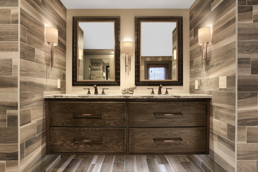 Inspiration for a large asian master bathroom in Other with flat-panel cabinets, dark wood cabinets, a curbless shower, multi-coloured tile, stone tile, multi-coloured walls, pebble tile floors, an undermount sink, granite benchtops and a drop-in tub.