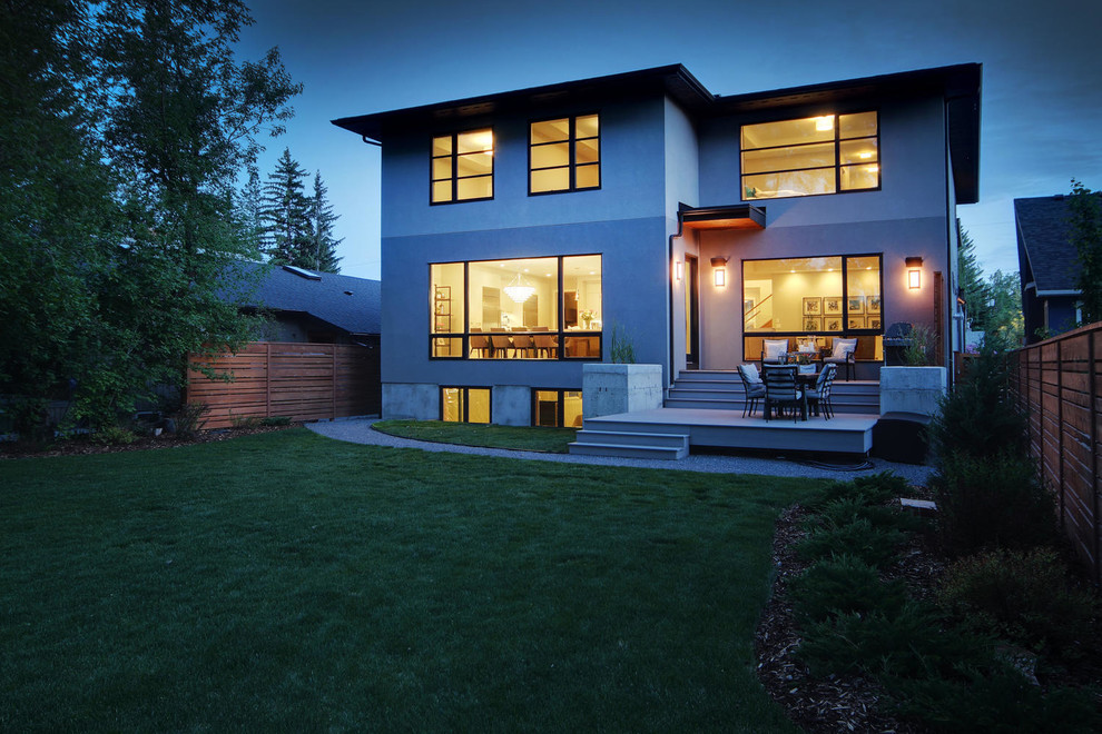 Home design - large transitional two-story stucco gray home design idea in Calgary with a hip roof and a shingle roof