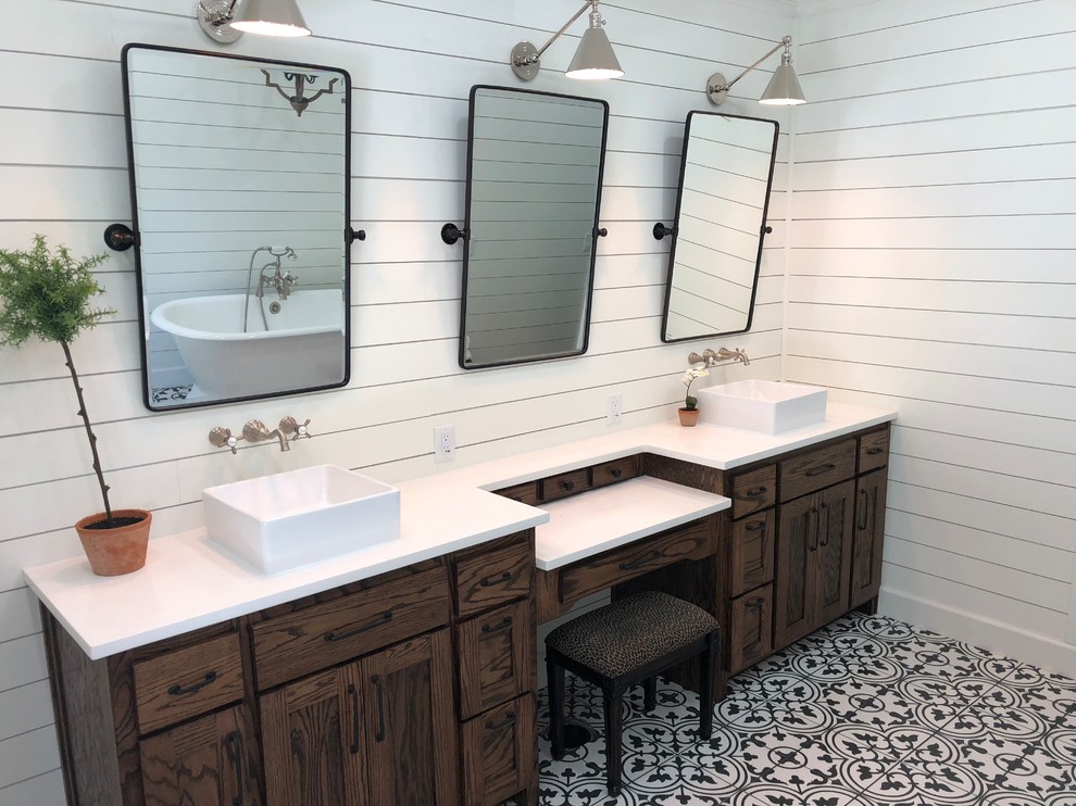 Photo of a large country master bathroom in Other with shaker cabinets, dark wood cabinets, a freestanding tub, an alcove shower, white walls, porcelain floors, a vessel sink, engineered quartz benchtops, multi-coloured floor, a hinged shower door and white benchtops.
