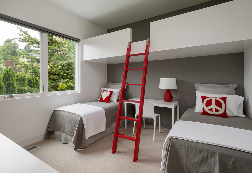 Mid-sized modern gender-neutral kids' bedroom in Seattle with grey walls, carpet and beige floor for kids 4-10 years old.