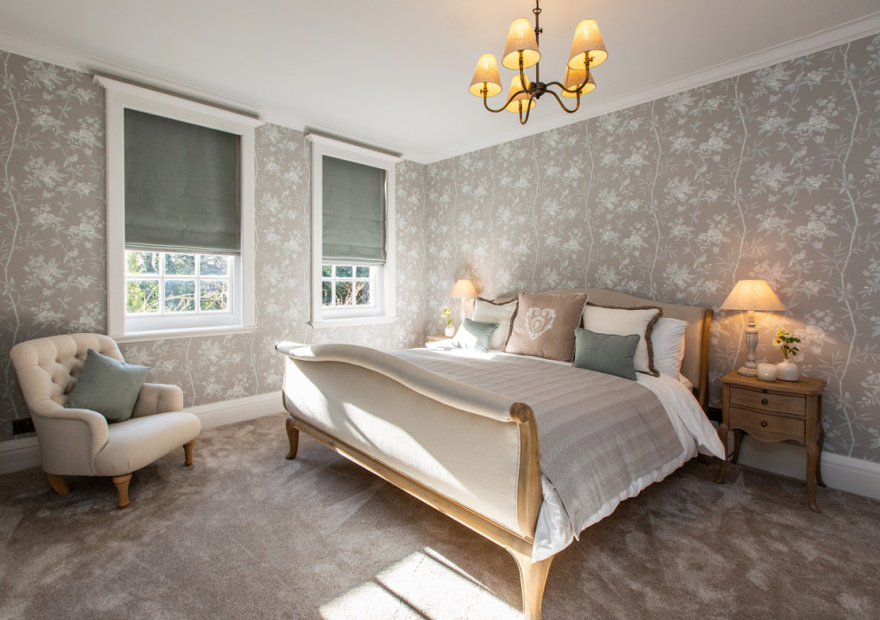 This is an example of a mid-sized traditional master bedroom in Surrey with carpet, wallpaper, multi-coloured walls and grey floor.