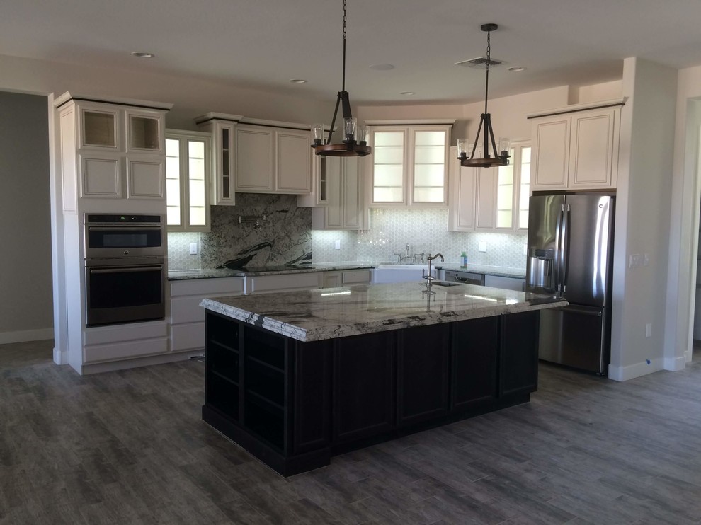 Inspiration for a mid-sized transitional u-shaped dark wood floor eat-in kitchen remodel in Phoenix with a farmhouse sink, recessed-panel cabinets, dark wood cabinets, wood countertops, white backsplash, subway tile backsplash, stainless steel appliances and no island