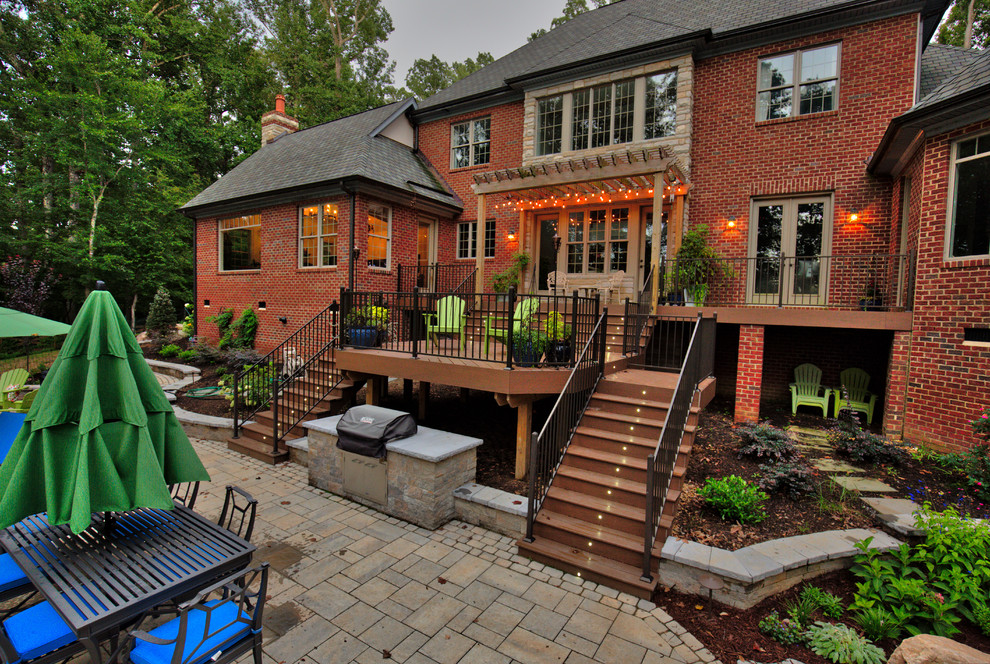 Patio - mid-sized traditional backyard stone patio idea in Richmond with a pergola