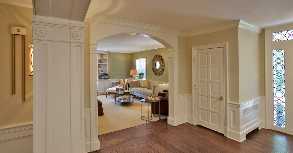 Design ideas for a large contemporary foyer in DC Metro with beige walls, dark hardwood floors and a single front door.