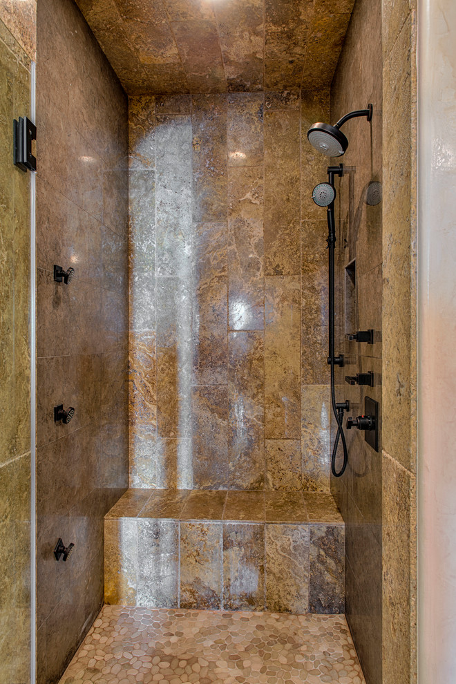 This is an example of a country master bathroom in Los Angeles with an alcove shower, stone tile and travertine floors.