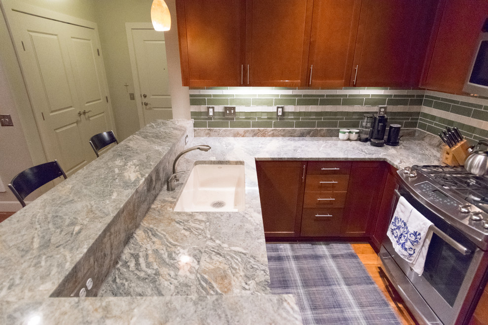 Inspiration for a transitional kitchen remodel with an undermount sink, granite countertops, green backsplash, stone slab backsplash and stainless steel appliances