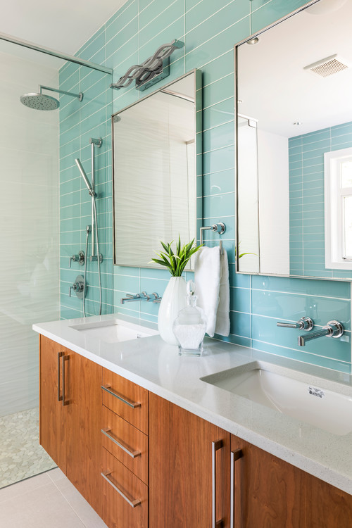 Vibrant Contrast with Light Blue Glass Bathroom Backsplash and Wood Vanity