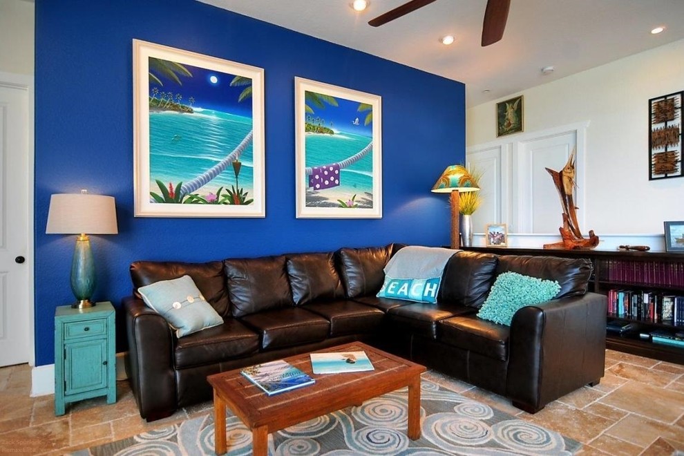 Inspiration for a mid-sized tropical enclosed living room in Orlando with blue walls, limestone floors, no fireplace and no tv.