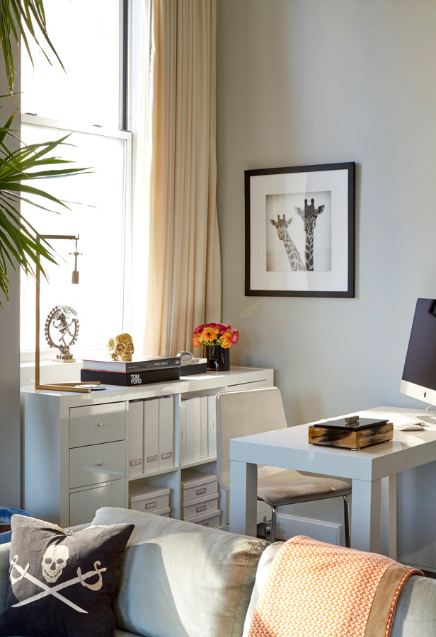 Small eclectic home office in New York with grey walls, dark hardwood floors and a freestanding desk.