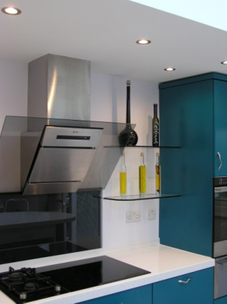 Inspiration for a modern kitchen with an island, flat-panel cabinets, turquoise cabinets, composite countertops, glass sheet splashback, a submerged sink and lino flooring.