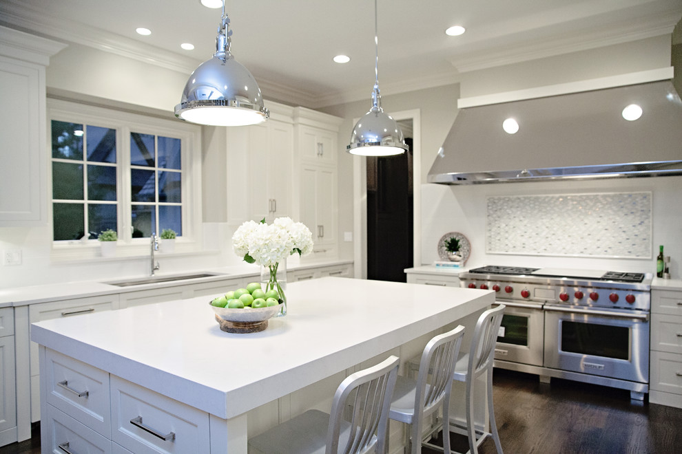 Inspiration for a mid-sized transitional single-wall slate floor enclosed kitchen remodel in Chicago with an undermount sink, recessed-panel cabinets, dark wood cabinets, solid surface countertops, green backsplash, mosaic tile backsplash, stainless steel appliances and an island