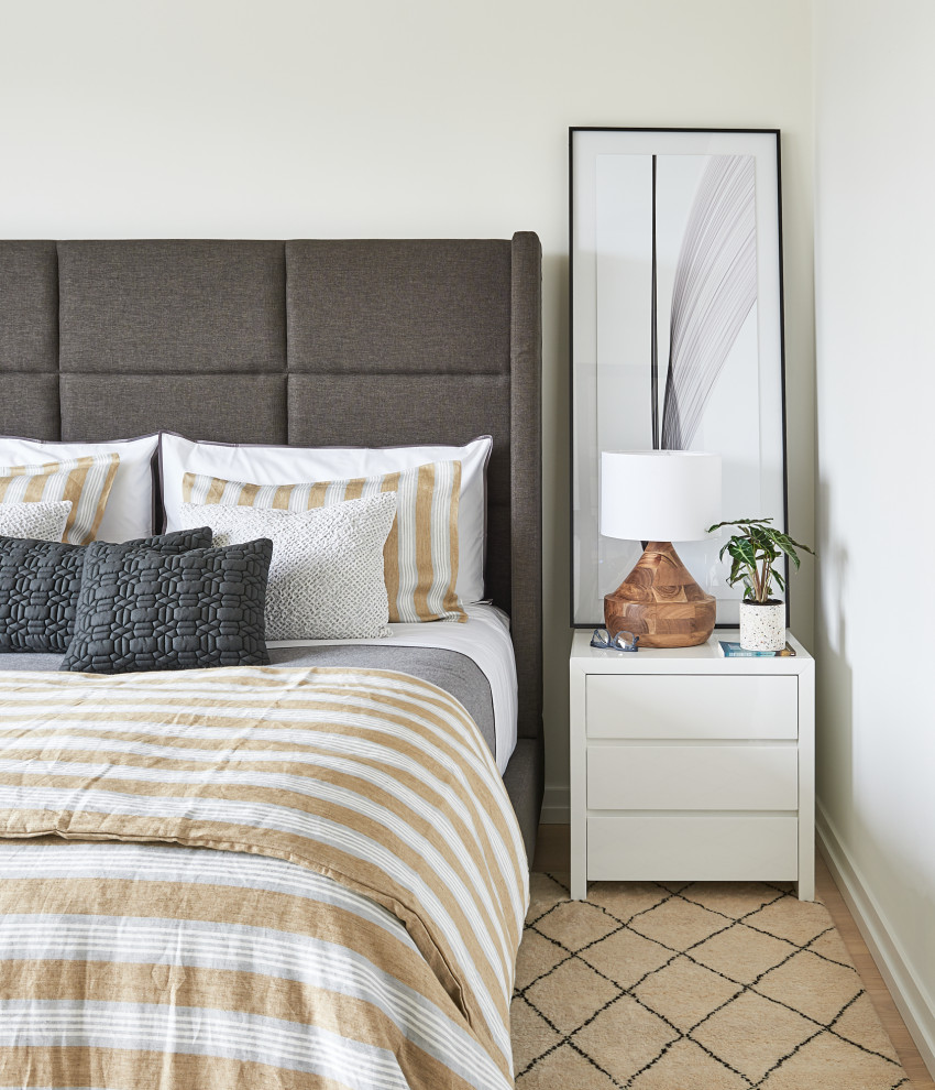 Inspiration for a mid-sized modern master bedroom in Toronto with white walls, light hardwood floors and white floor.