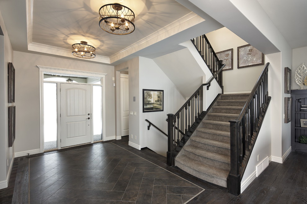 Transitional ceramic tile foyer photo in Calgary with white walls and a white front door
