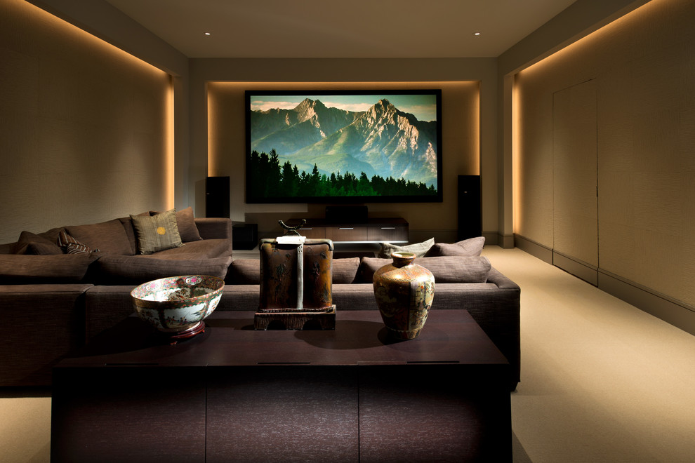 Enclosed home theatre in Boston with beige walls, carpet and a projector screen.