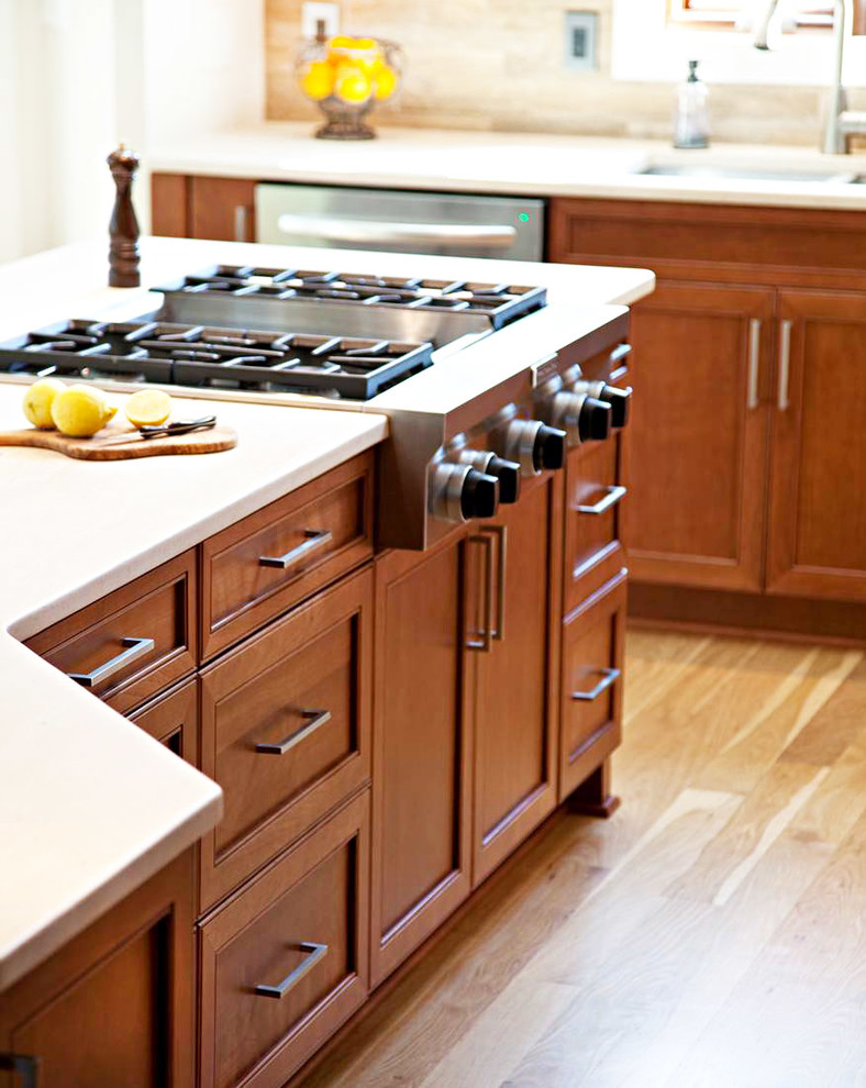 Eat-in kitchen - transitional l-shaped eat-in kitchen idea in Charlotte with an undermount sink, flat-panel cabinets, medium tone wood cabinets, quartz countertops, beige backsplash, stone tile backsplash and stainless steel appliances