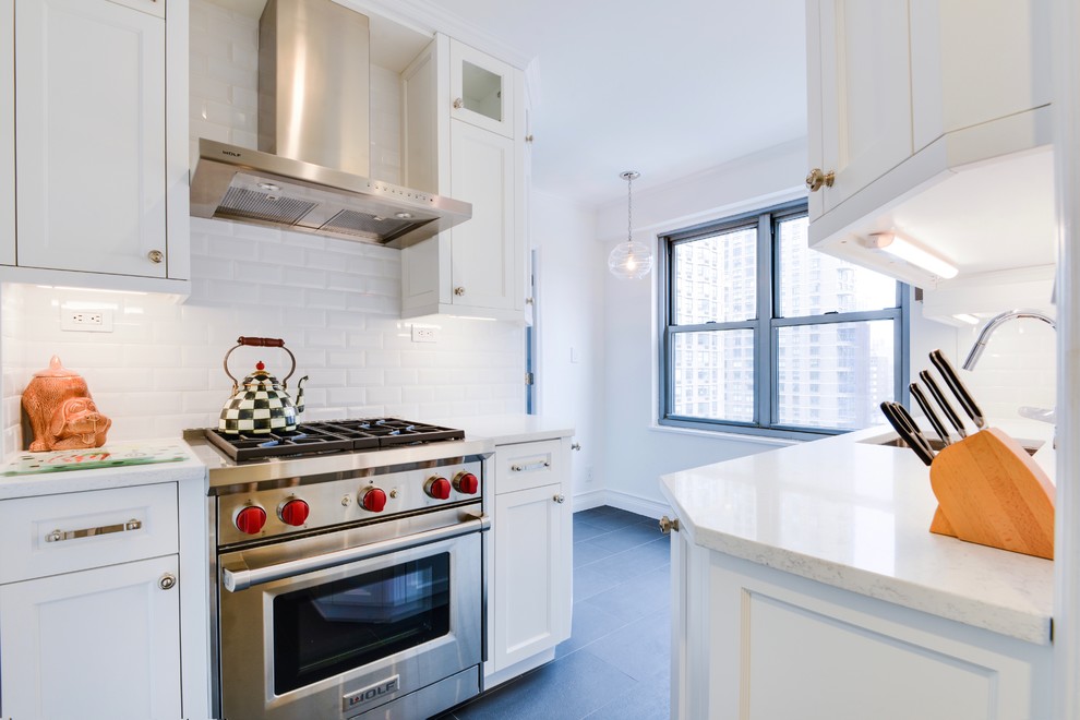 Inspiration for a mid-sized transitional u-shaped gray floor eat-in kitchen remodel with an undermount sink, shaker cabinets, white cabinets, stainless steel appliances and no island
