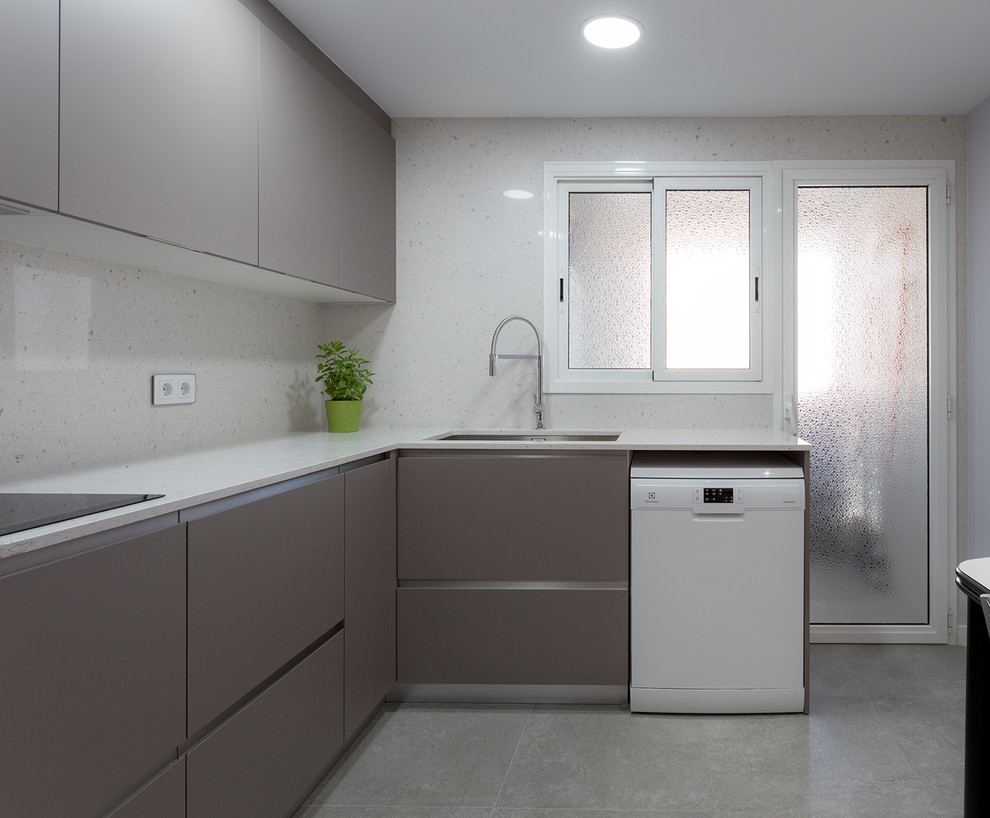 Design ideas for a mid-sized contemporary l-shaped separate kitchen in Barcelona with a single-bowl sink, flat-panel cabinets, beige cabinets, stainless steel appliances, ceramic floors, no island and grey floor.