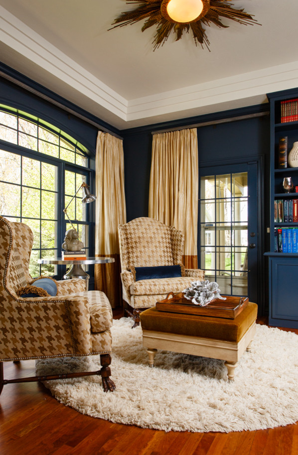 This is an example of a mid-sized transitional study room in Milwaukee with blue walls and medium hardwood floors.