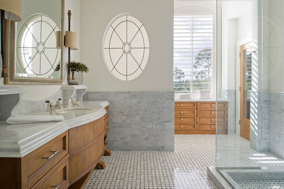 Design ideas for an expansive traditional master bathroom in Miami with an undermount sink, recessed-panel cabinets, medium wood cabinets, a corner shower, mosaic tile, mosaic tile floors and marble benchtops.