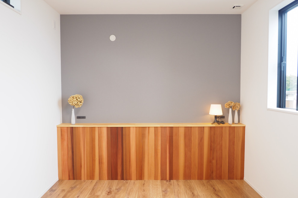 Idéer för funkis huvudsovrum, med grå väggar, plywoodgolv och brunt golv