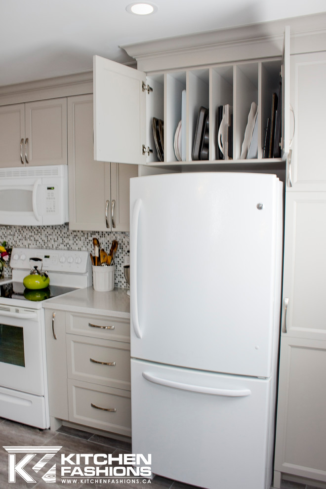 Open concept kitchen - mid-sized transitional single-wall ceramic tile open concept kitchen idea with an undermount sink, shaker cabinets, gray cabinets, solid surface countertops, gray backsplash, mosaic tile backsplash, white appliances and an island