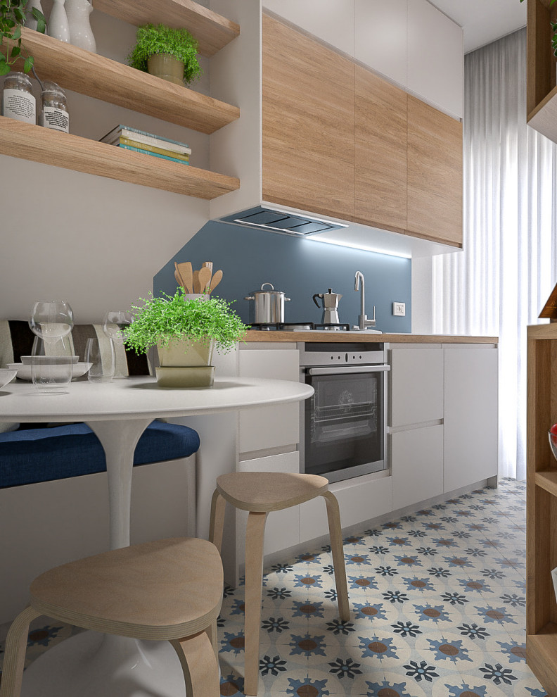 Inspiration for a small contemporary galley separate kitchen in Milan with a single-bowl sink, flat-panel cabinets, white cabinets, wood benchtops, blue splashback, stainless steel appliances, porcelain floors, a peninsula, multi-coloured floor and recessed.