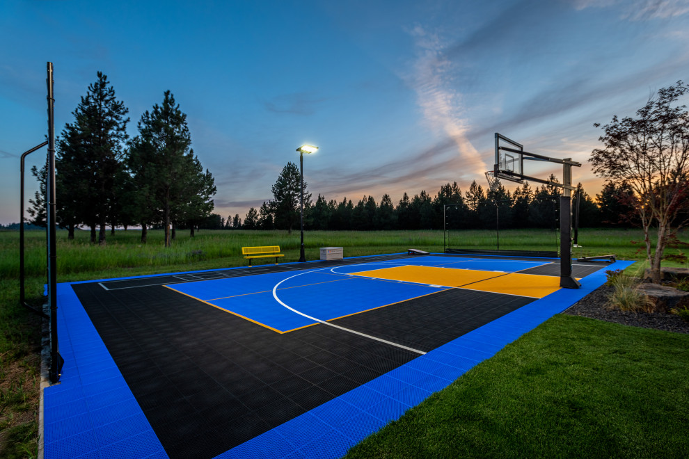 This is an example of a large traditional backyard full sun outdoor sport court in Seattle with with flowerbed and natural stone pavers.