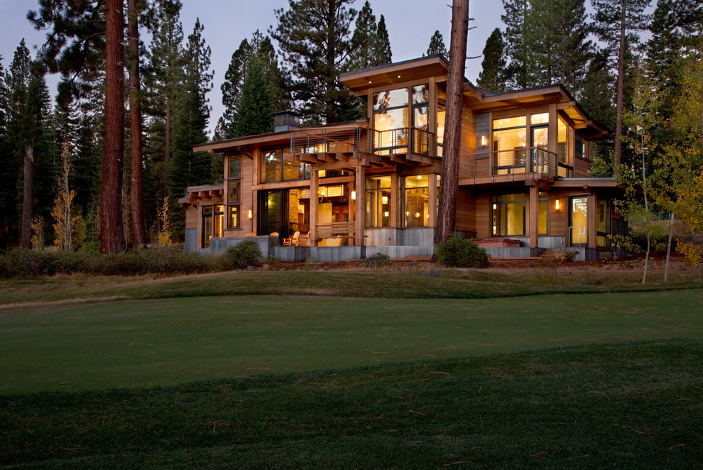 Example of a mountain style wood exterior home design in Sacramento with a shed roof
