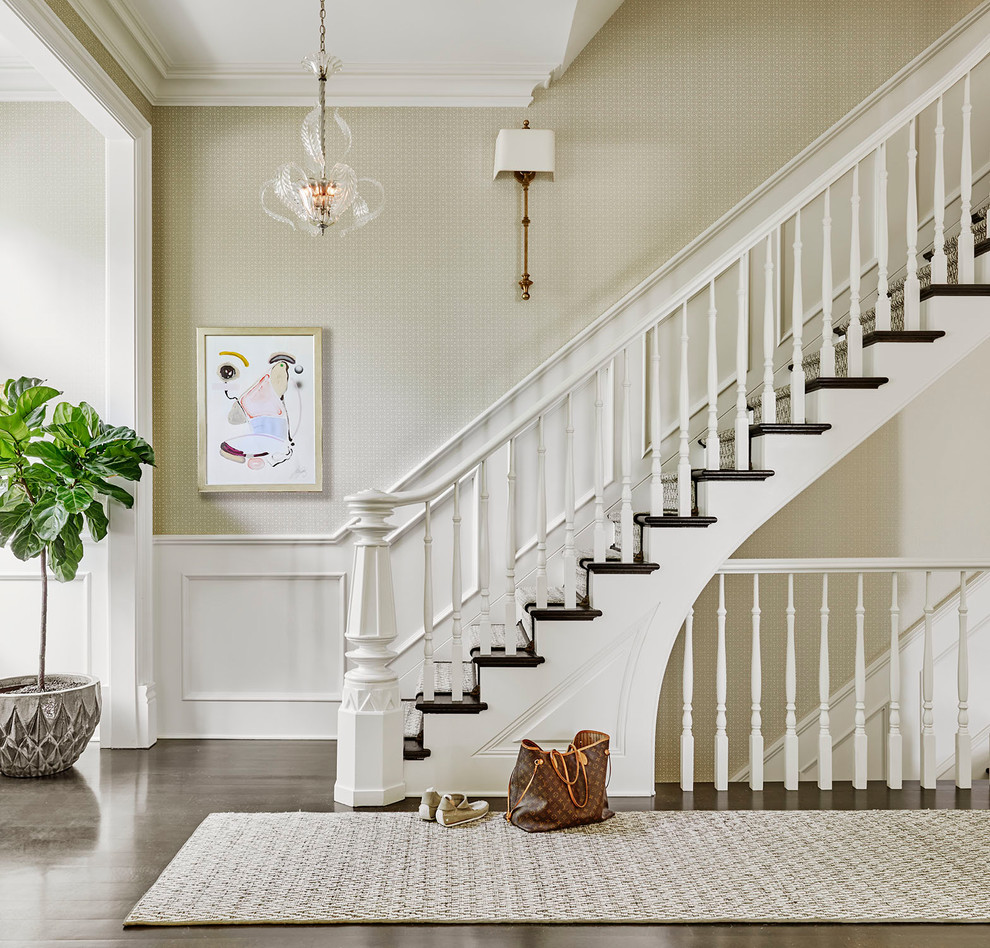 Photo of a mid-sized traditional wood straight staircase in Chicago with painted wood risers and wood railing.