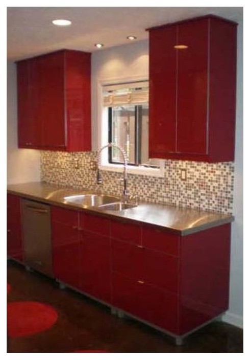 Photo of a mid-sized contemporary galley eat-in kitchen in Atlanta with an integrated sink, flat-panel cabinets, red cabinets, stainless steel benchtops, beige splashback, ceramic splashback, stainless steel appliances, concrete floors and no island.