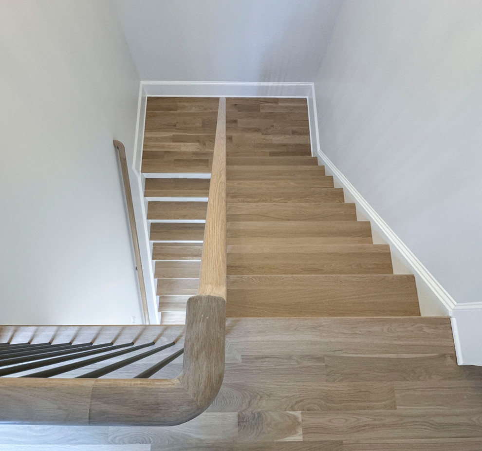 Large traditional wood floating staircase in DC Metro with painted wood risers and mixed railing.