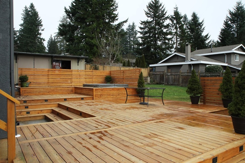 Large mountain style backyard water fountain deck photo in Vancouver with no cover
