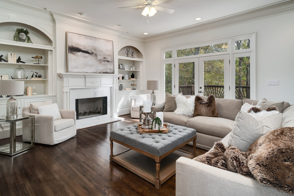 Large transitional formal living room in Birmingham with white walls, medium hardwood floors, a standard fireplace, no tv and brown floor.