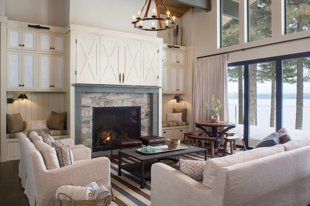 Inspiration for a beach style family room in Sacramento with white walls, dark hardwood floors, a standard fireplace, a stone fireplace surround, a concealed tv and vaulted.