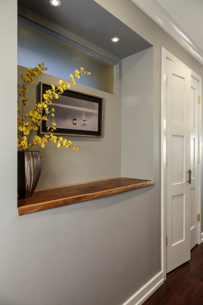 Hallway - mid-sized transitional medium tone wood floor hallway idea in Baltimore with white walls