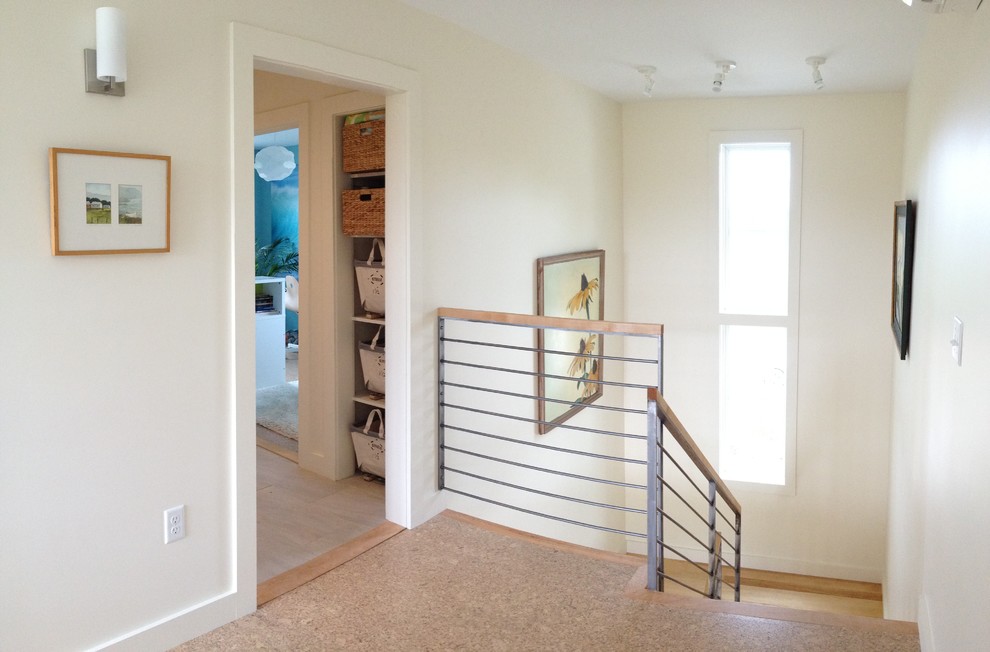 This is an example of a small transitional wood u-shaped staircase in Burlington with painted wood risers.