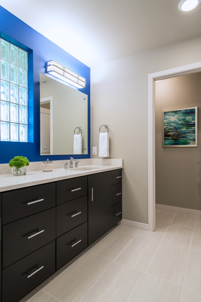 Photo of a small contemporary master bathroom in Dallas with a drop-in sink, flat-panel cabinets, dark wood cabinets, engineered quartz benchtops, an alcove shower, a one-piece toilet, gray tile, porcelain tile, grey walls and porcelain floors.